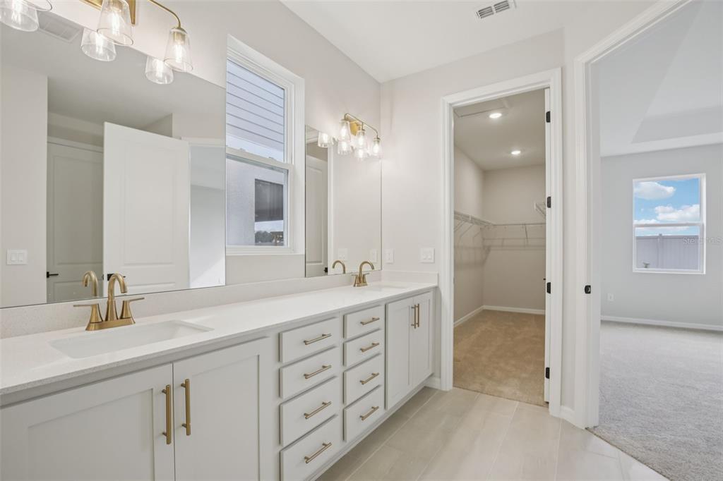 10167 Hidden Hammock Loop Parrish, FL 34221 - Photo 26 of 42 a spacious bathroom with a double vanity sink mirror and double