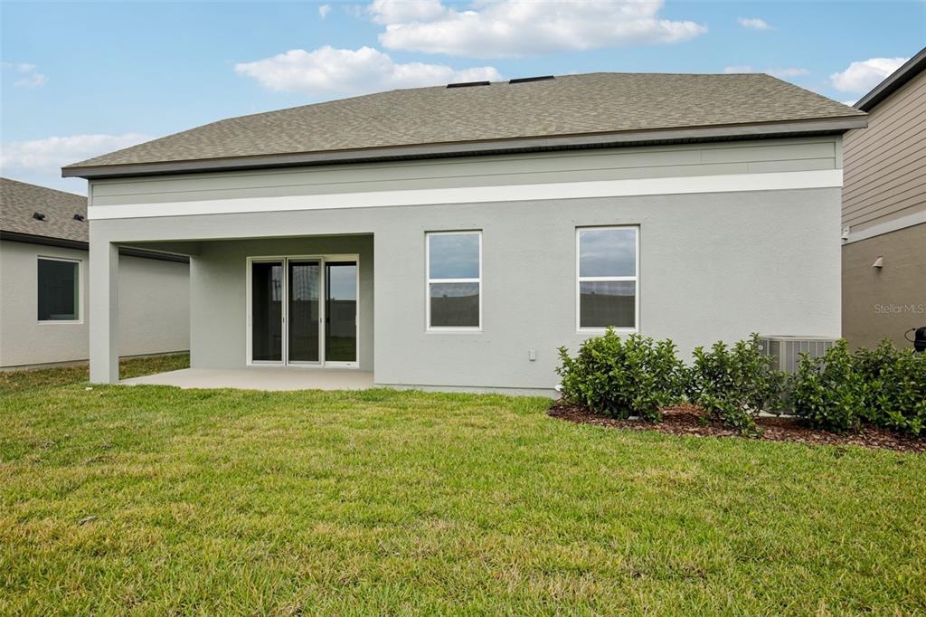 10167 Hidden Hammock Loop Parrish, FL 34221 - Photo 40 of 42 a house that has a big yard with potted plants