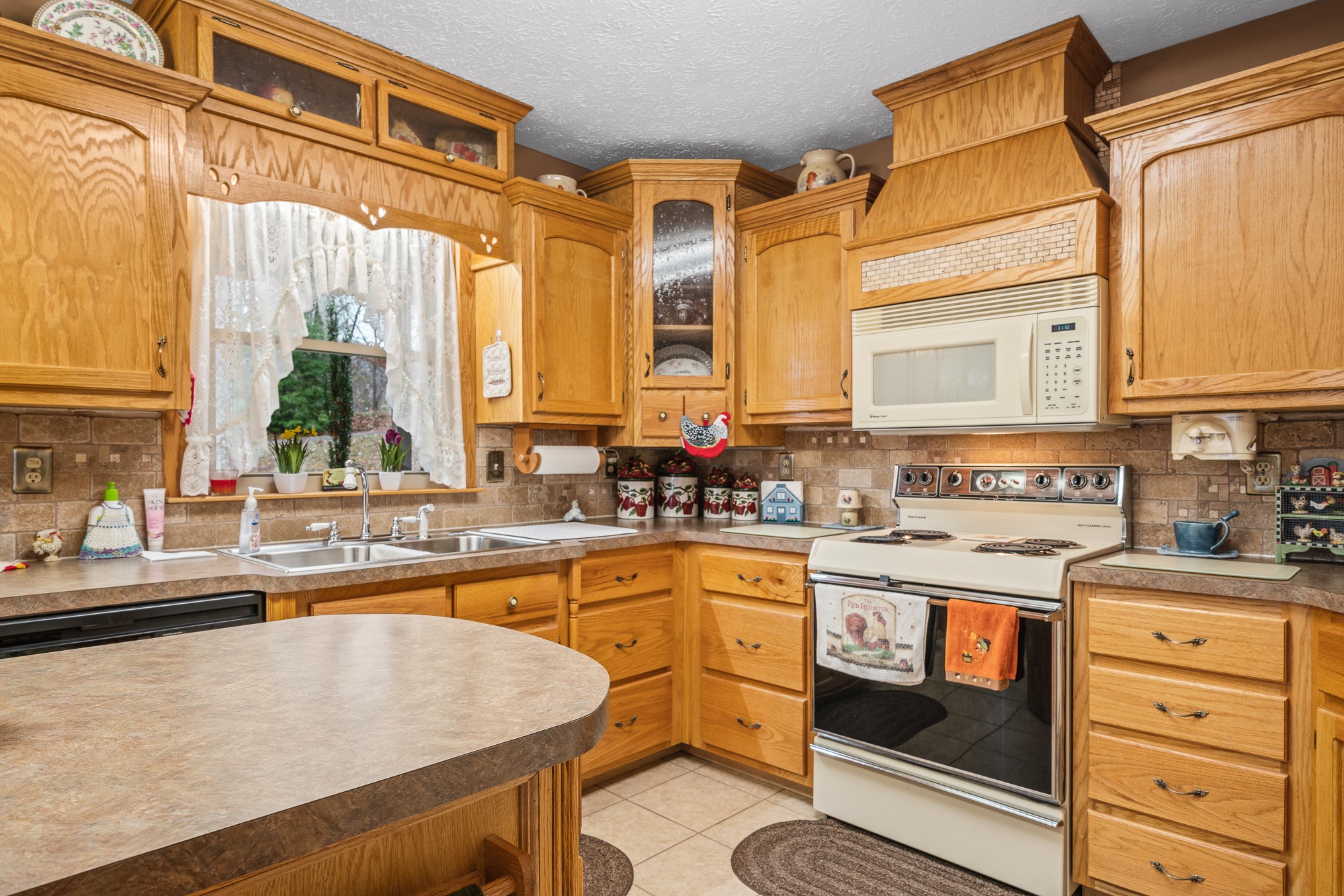 645 Rocky Top Road Sparta, TN 38583 - Photo 14 of 29 a kitchen with a stove a sink and a microwave