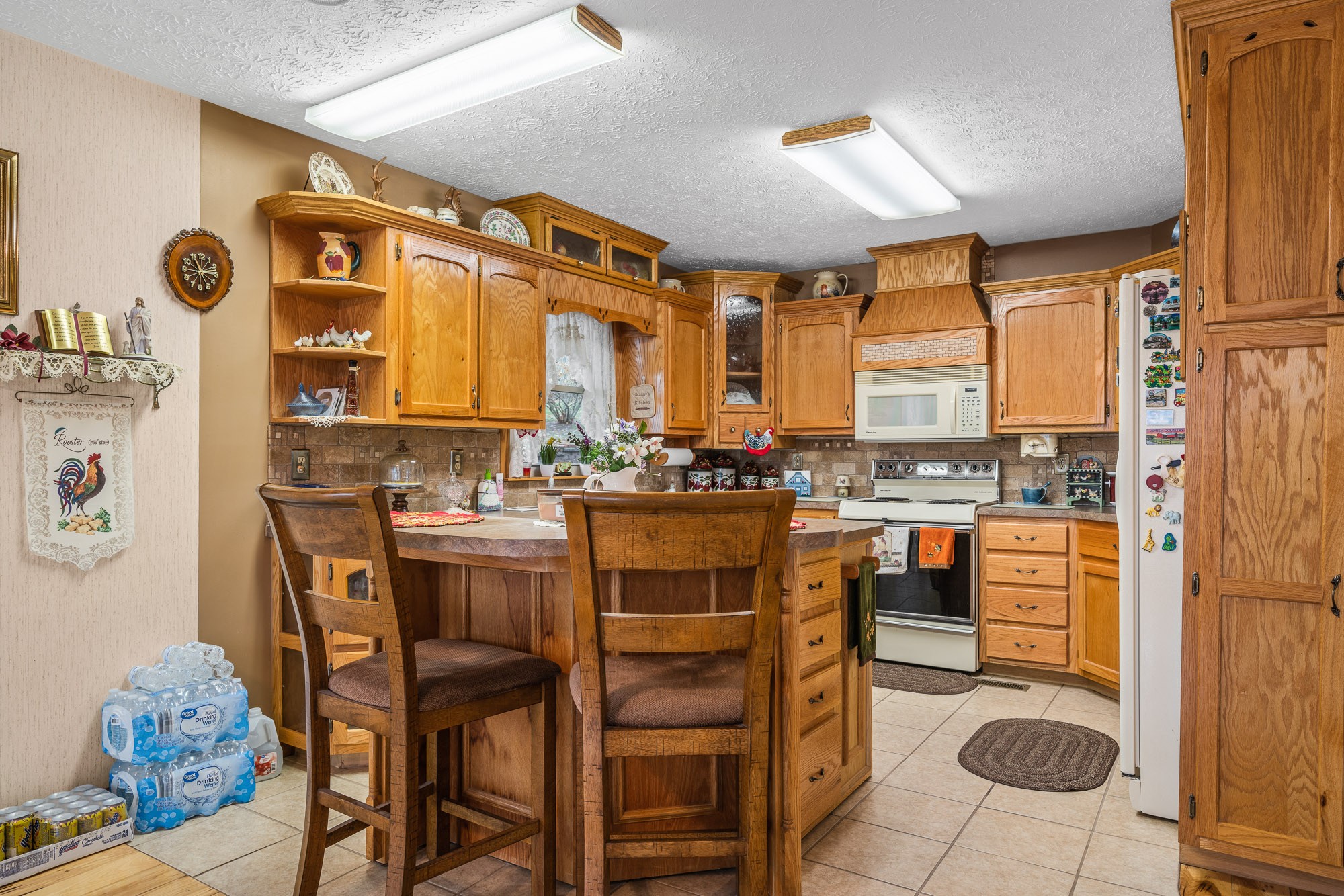 645 Rocky Top Road Sparta, TN 38583 - Photo 15 of 29 a dining room with stainless steel appliances kitchen island granite countertop a table chairs and a refrigerator