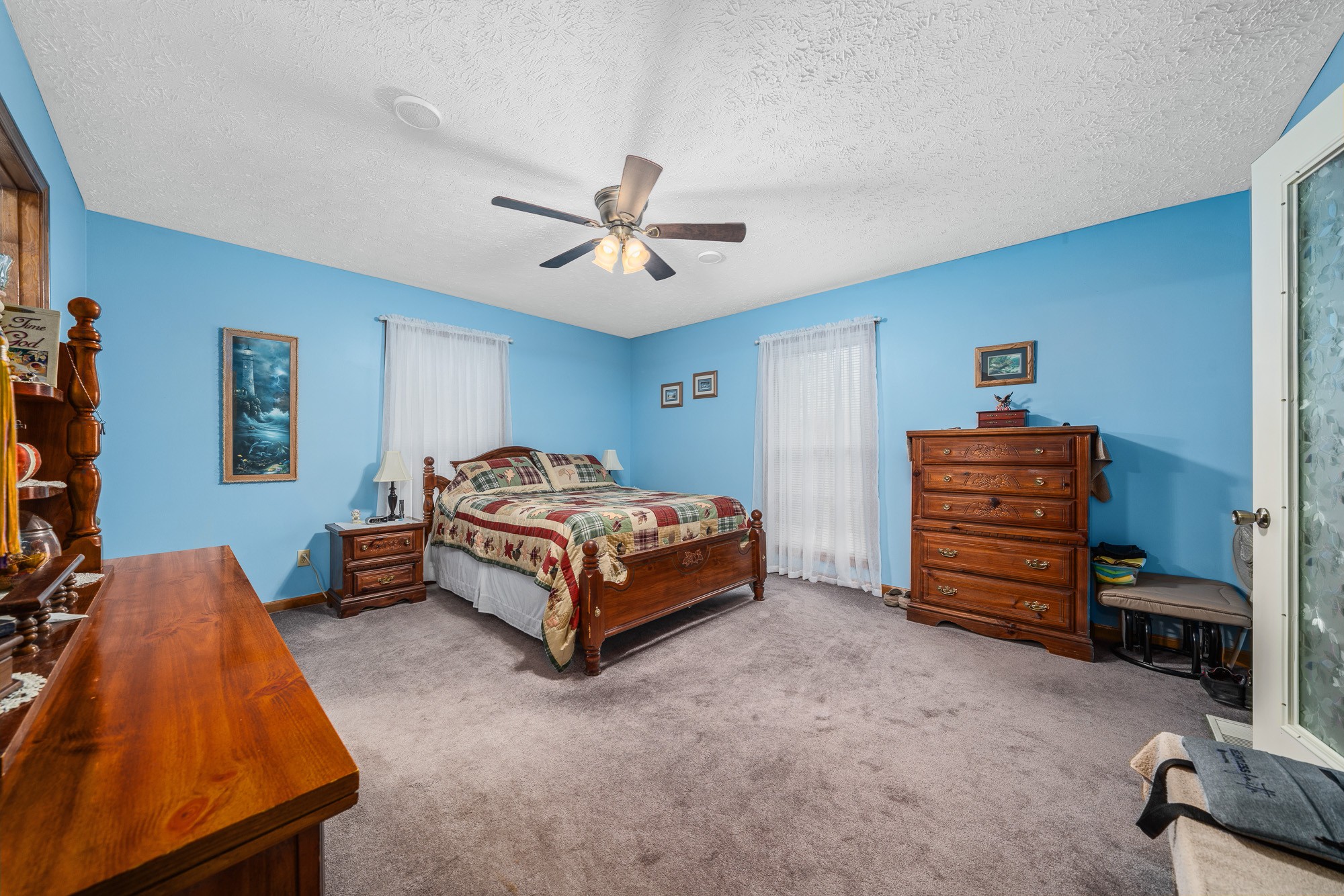 645 Rocky Top Road Sparta, TN 38583 - Photo 22 of 29 a bedroom with a bed and a chandelier
