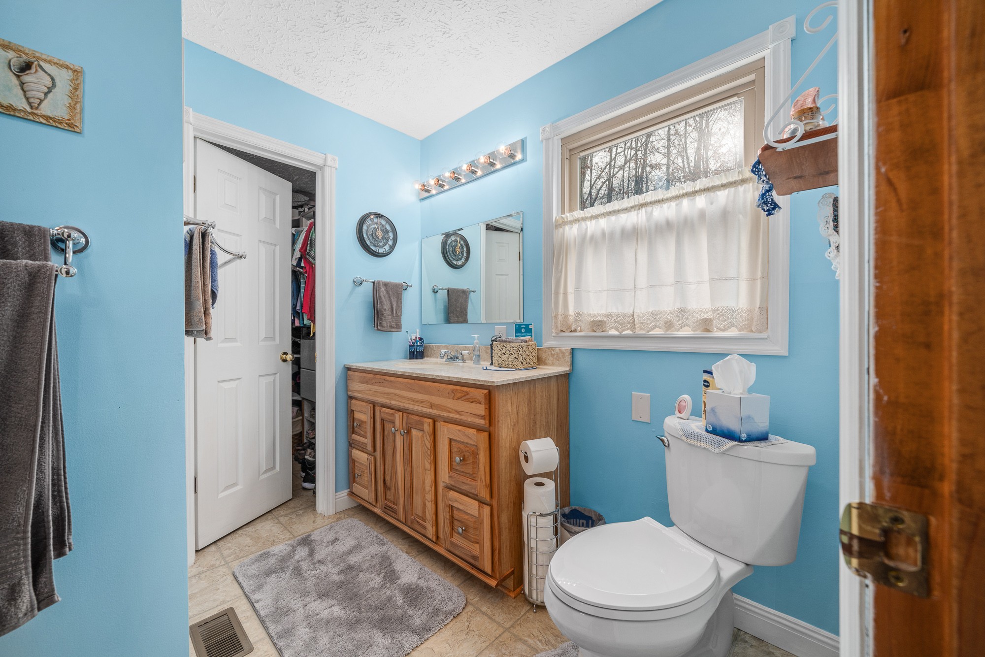 645 Rocky Top Road Sparta, TN 38583 - Photo 23 of 29 a bathroom with a granite countertop toilet sink and mirror