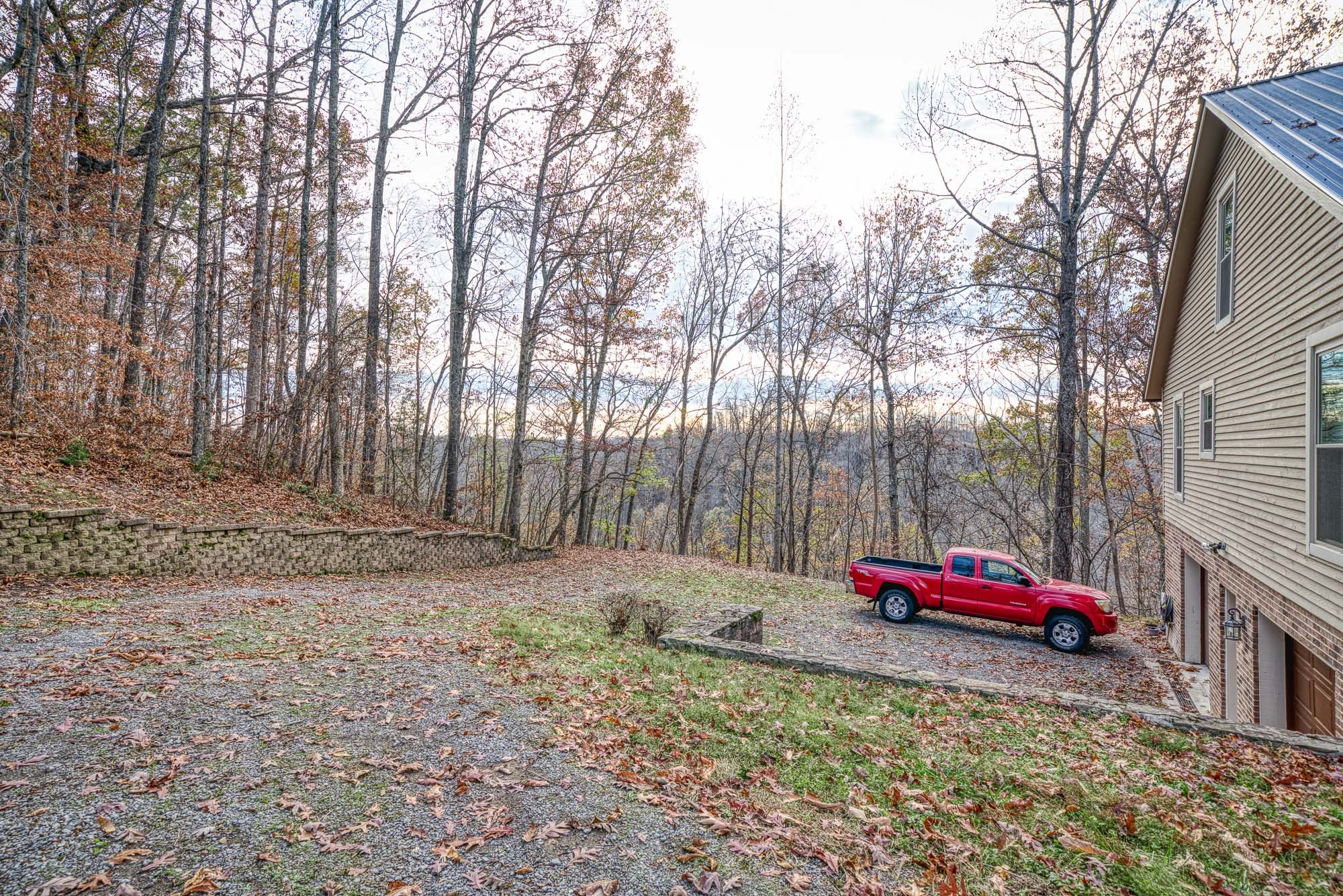 645 Rocky Top Road Sparta, TN 38583 - Photo 5 of 29 a backyard of a house with cars parked on the road