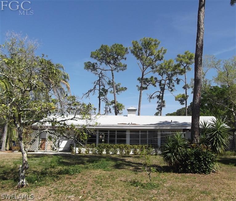7310 Coon Road North Fort Myers, FL 33917 - Photo 8 of 10 a front view of a house with a yard and potted plants