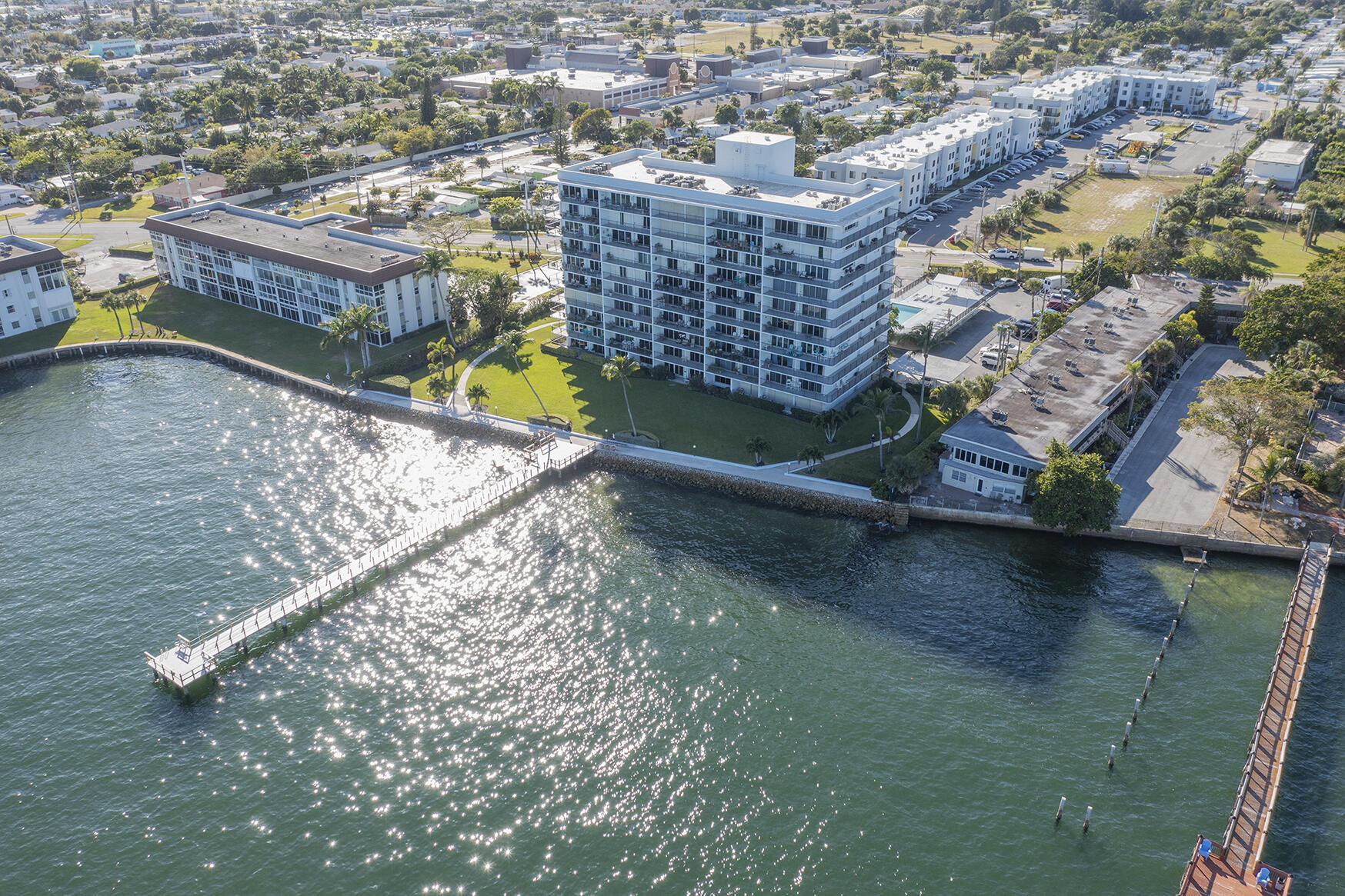 an aerial view of residential houses with outdoor space and lake view