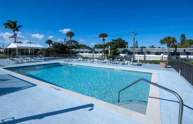 a view of a swimming pool with outdoor seating and a patio