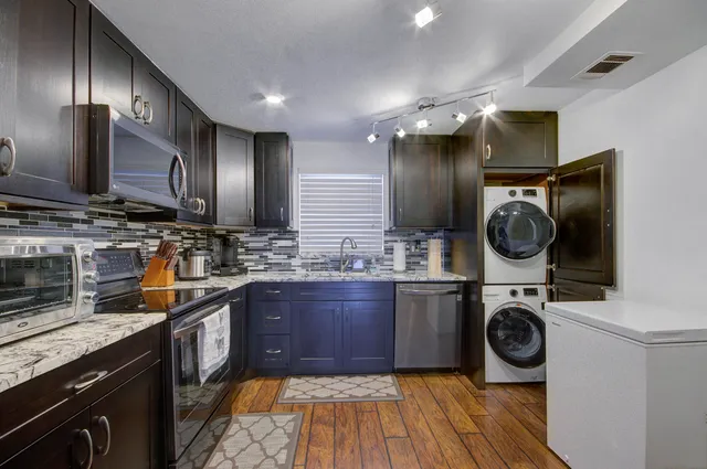 a kitchen with wooden cabinets and stainless steel appliances