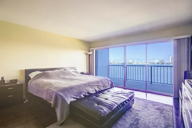 a bedroom with a bed window and a rug