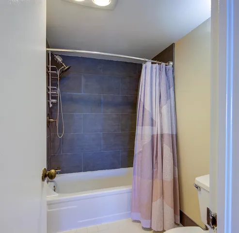 a bathroom with a shower and a tub