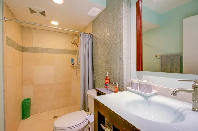 a bathroom with a sink toilet and shower