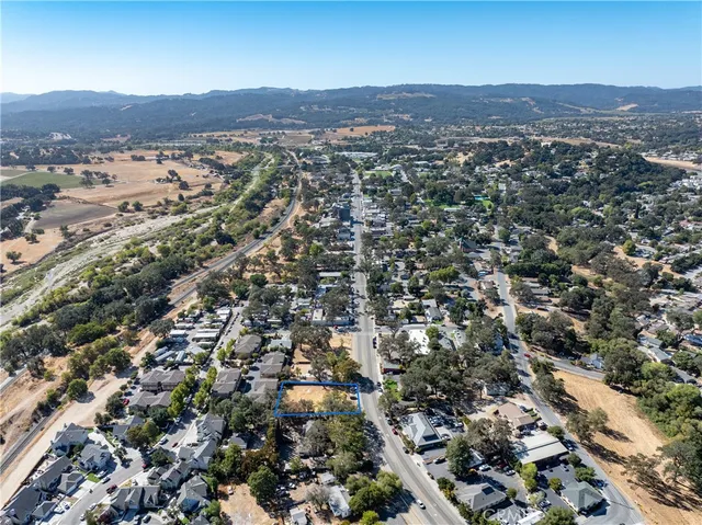 an aerial view of residential houses with city view