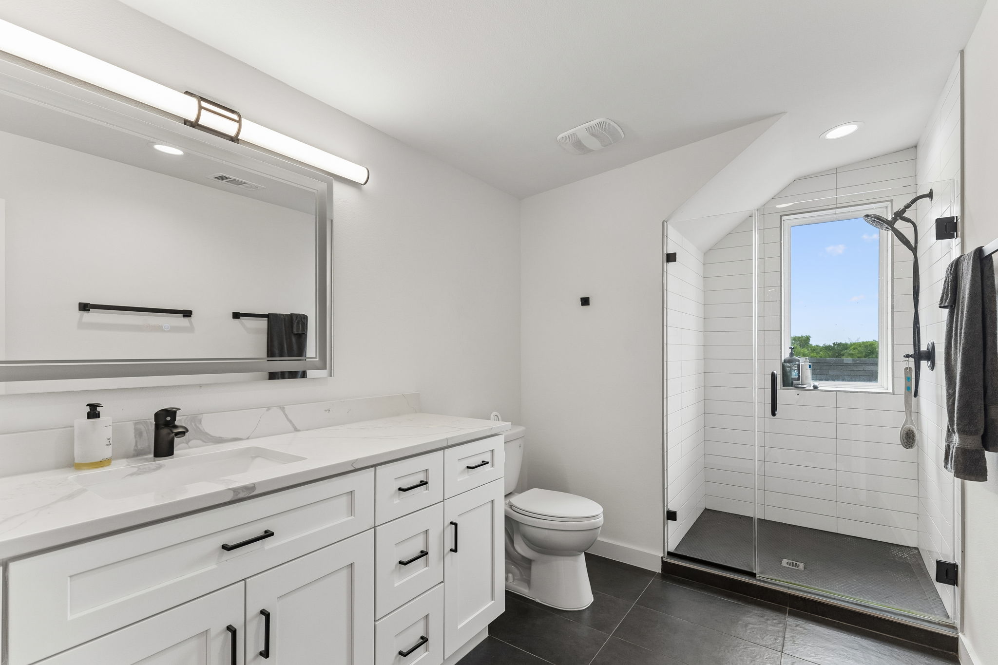 5305 Ledesma Road, Unit 1 Austin, TX 78721 - Photo 20 of 26 Bathroom featuring a spacious vanity with white cabinetry, a light-toned countertop, and an integrated sink with a black faucet