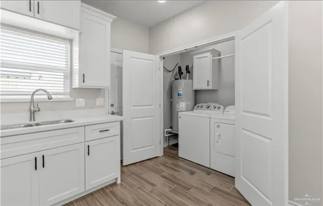 a view of a sink and dishwasher with wooden floor