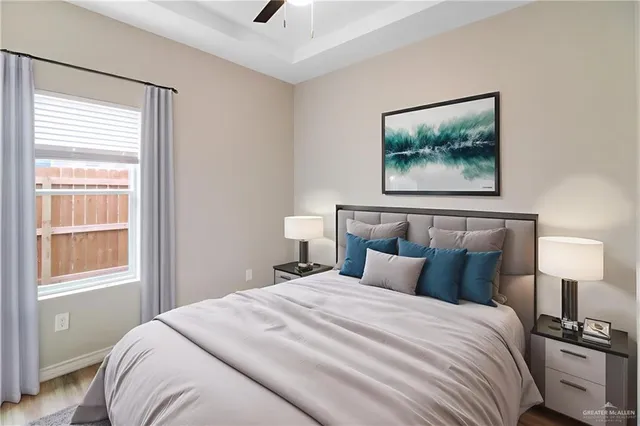 a bedroom with a bed and a painting on the wall