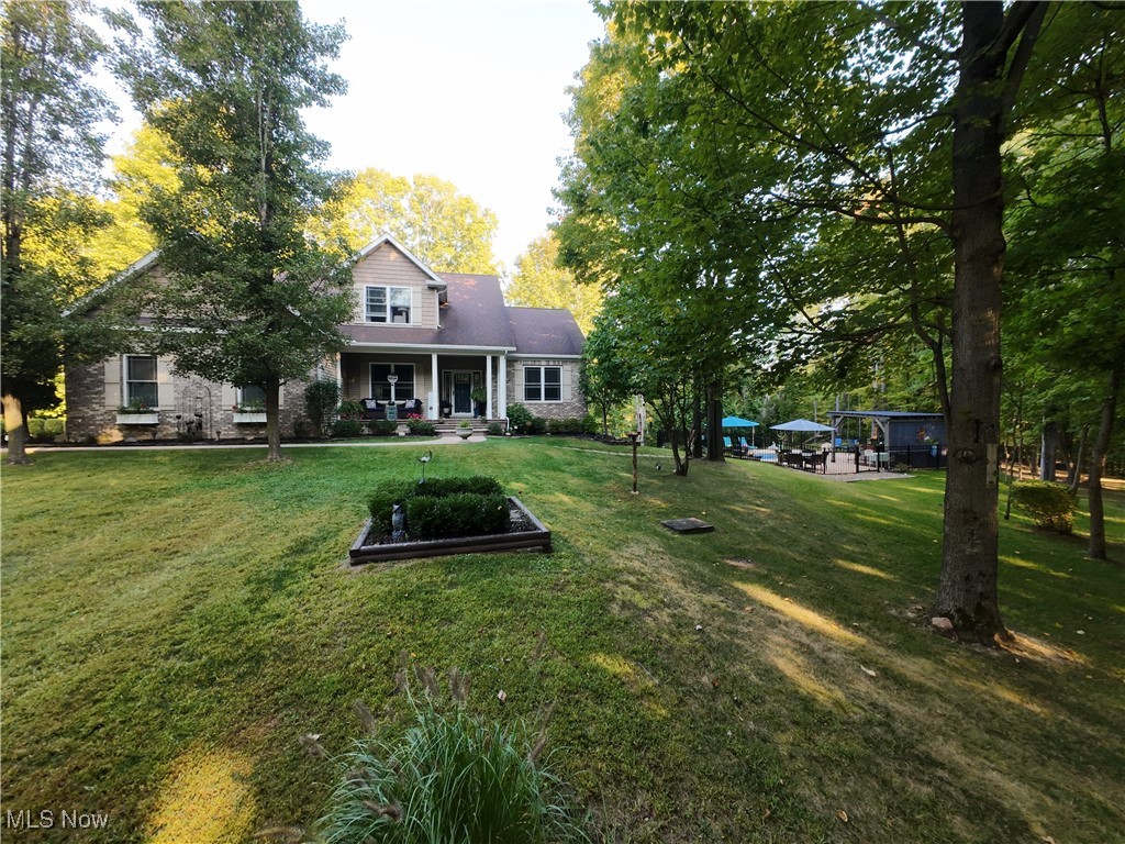 5232 Emerson Road Madison, OH 44057 - Photo 1 of 48 View of front of house featuring covered porch and a front lawn