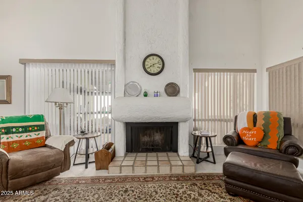 a living room with furniture a rug and a fireplace