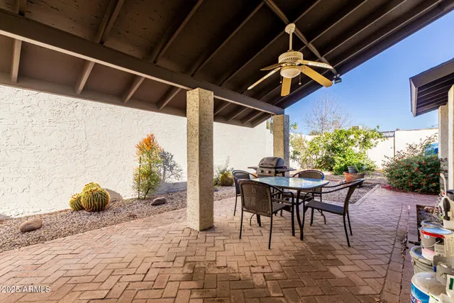 a view of a patio with table and chairs potted plants with wooden floor