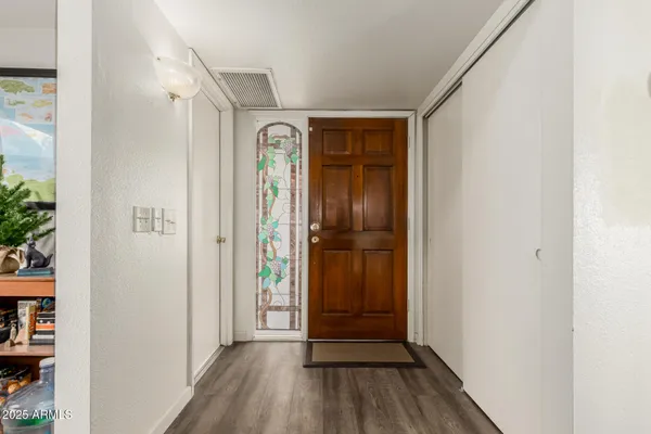 a view of a hallway with wooden floor
