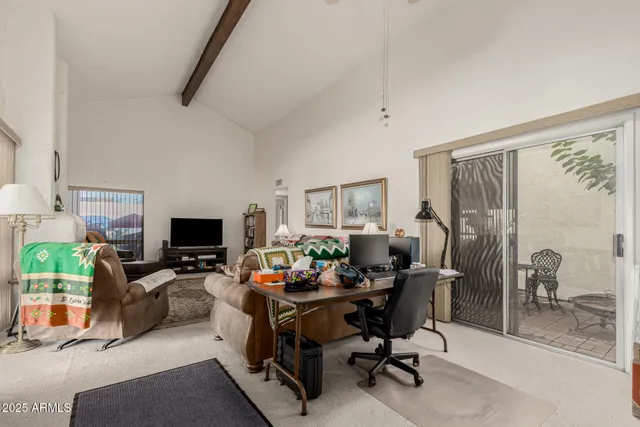 a view of a livingroom with workspace and a couch