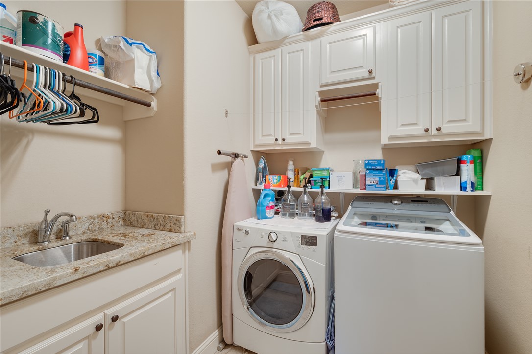 3301 Covington Court Bryan, TX 77808 - Photo 25 of 26 a utility room with sink dryer and washer