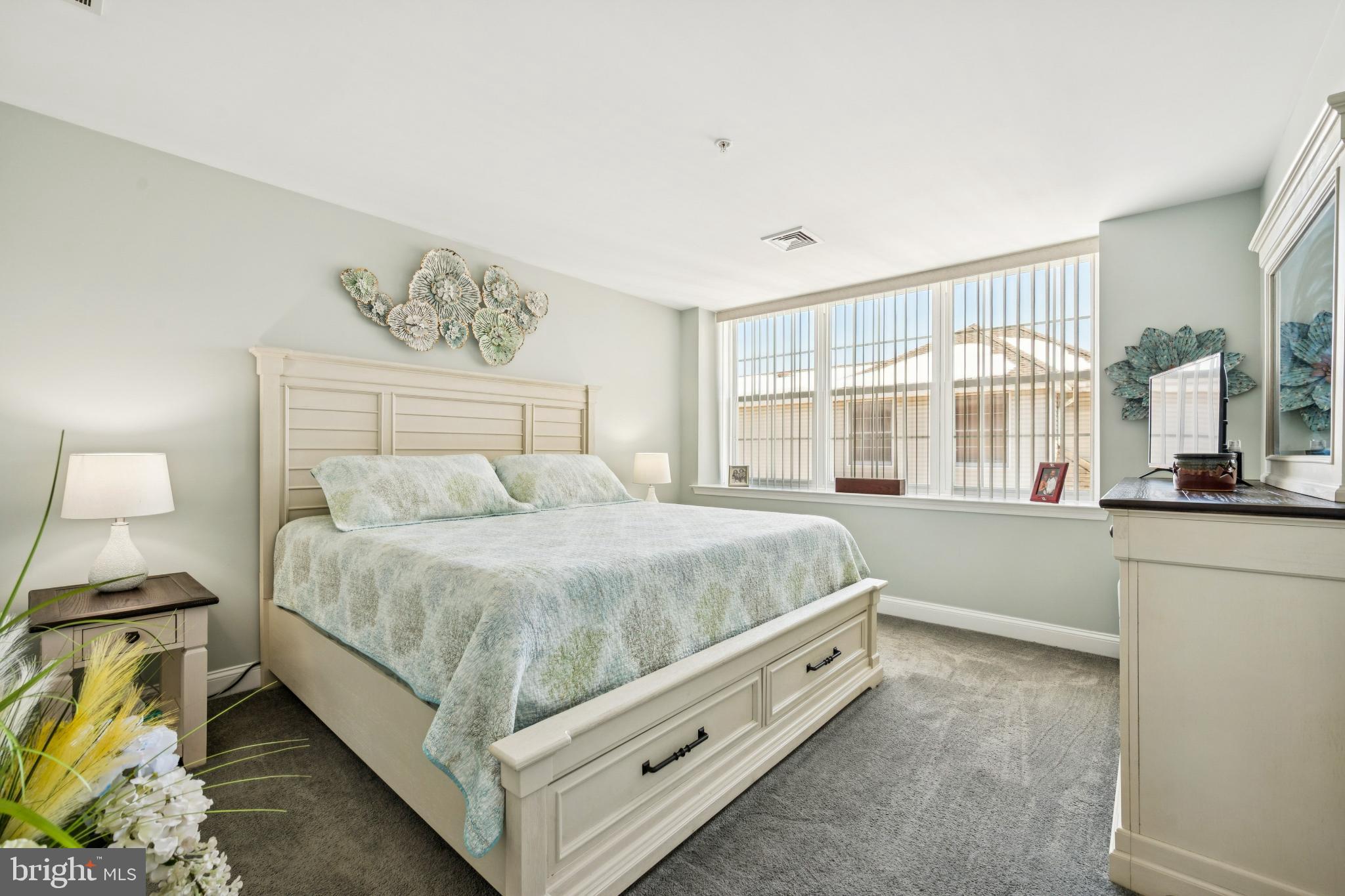 100 Aura Road, Unit 410 Clayton, NJ 08312 - Photo 16 of 25 Serene bedroom with natural light and charm.