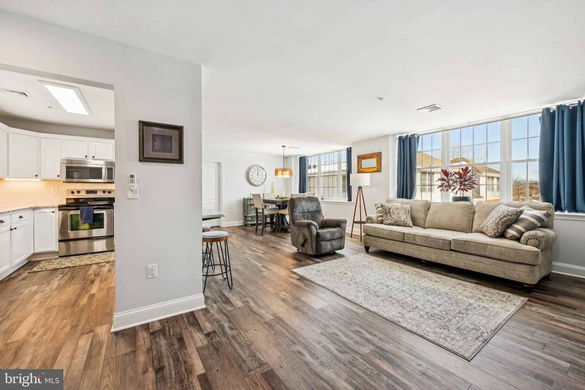 100 Aura Road, Unit 410 Clayton, NJ 08312 - Photo 2 of 25 Bright and inviting open-concept living space.