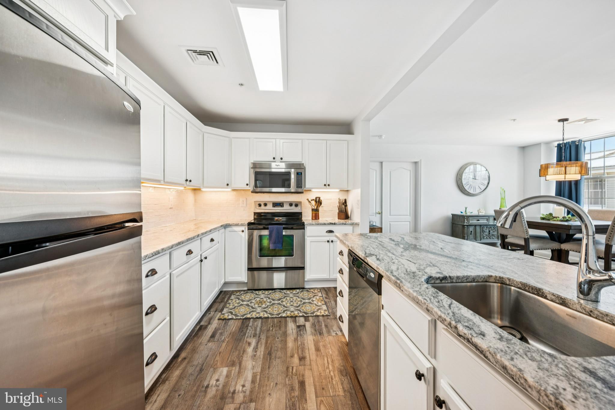 100 Aura Road, Unit 410 Clayton, NJ 08312 - Photo 4 of 25 Modern kitchen with sleek finishes and light.
