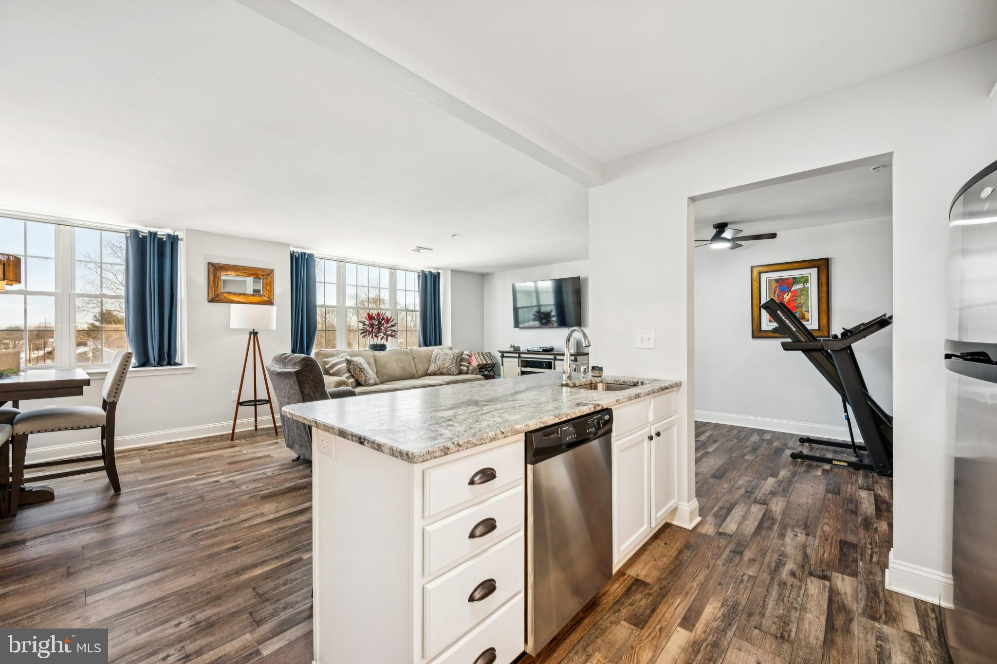 100 Aura Road, Unit 410 Clayton, NJ 08312 - Photo 8 of 25 Bright and airy open-concept living space.