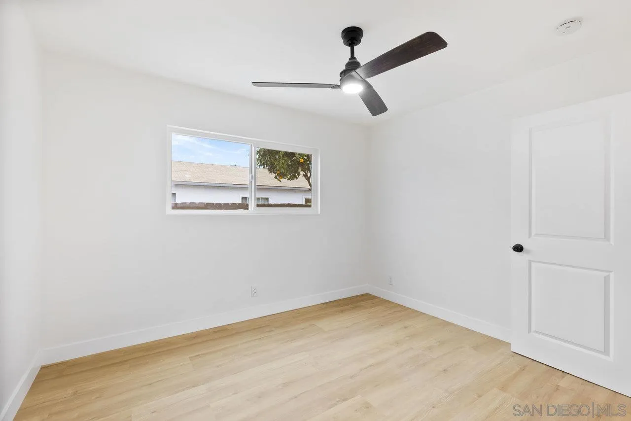1320 Higgins Street Oceanside, CA 92058 - Photo 16 of 25 an empty room with a window and a ceiling fan