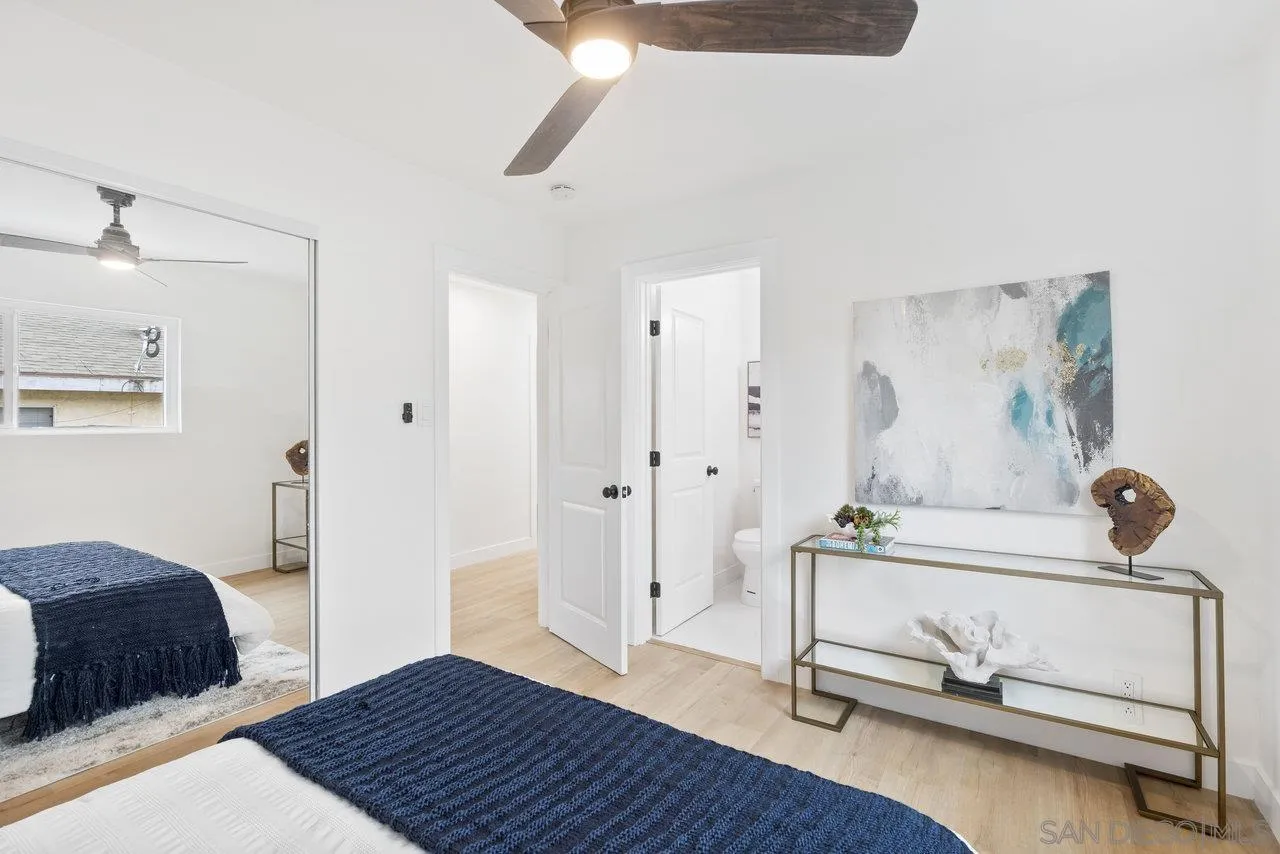 1320 Higgins Street Oceanside, CA 92058 - Photo 18 of 25 a bedroom with a bed and a chandelier