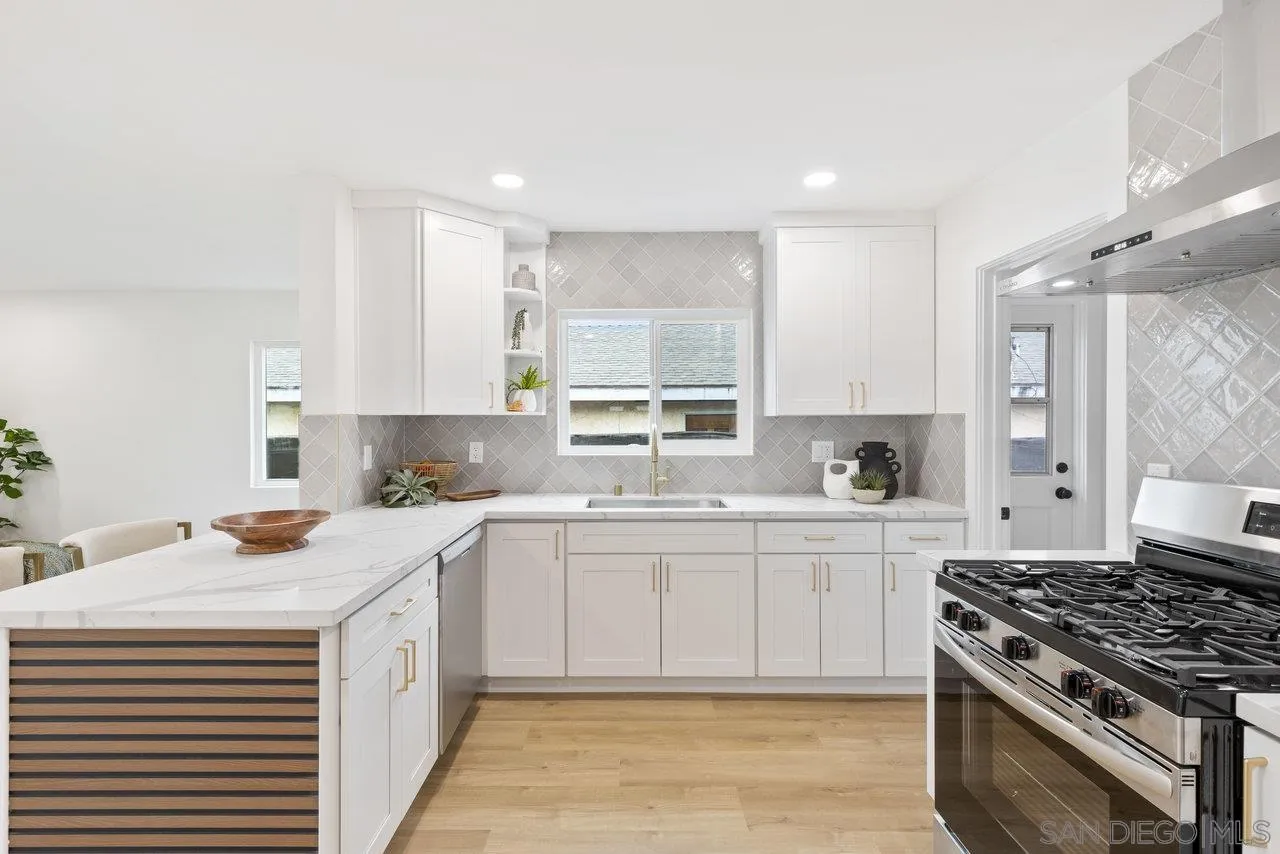 1320 Higgins Street Oceanside, CA 92058 - Photo 4 of 25 a kitchen with a sink stove and cabinets