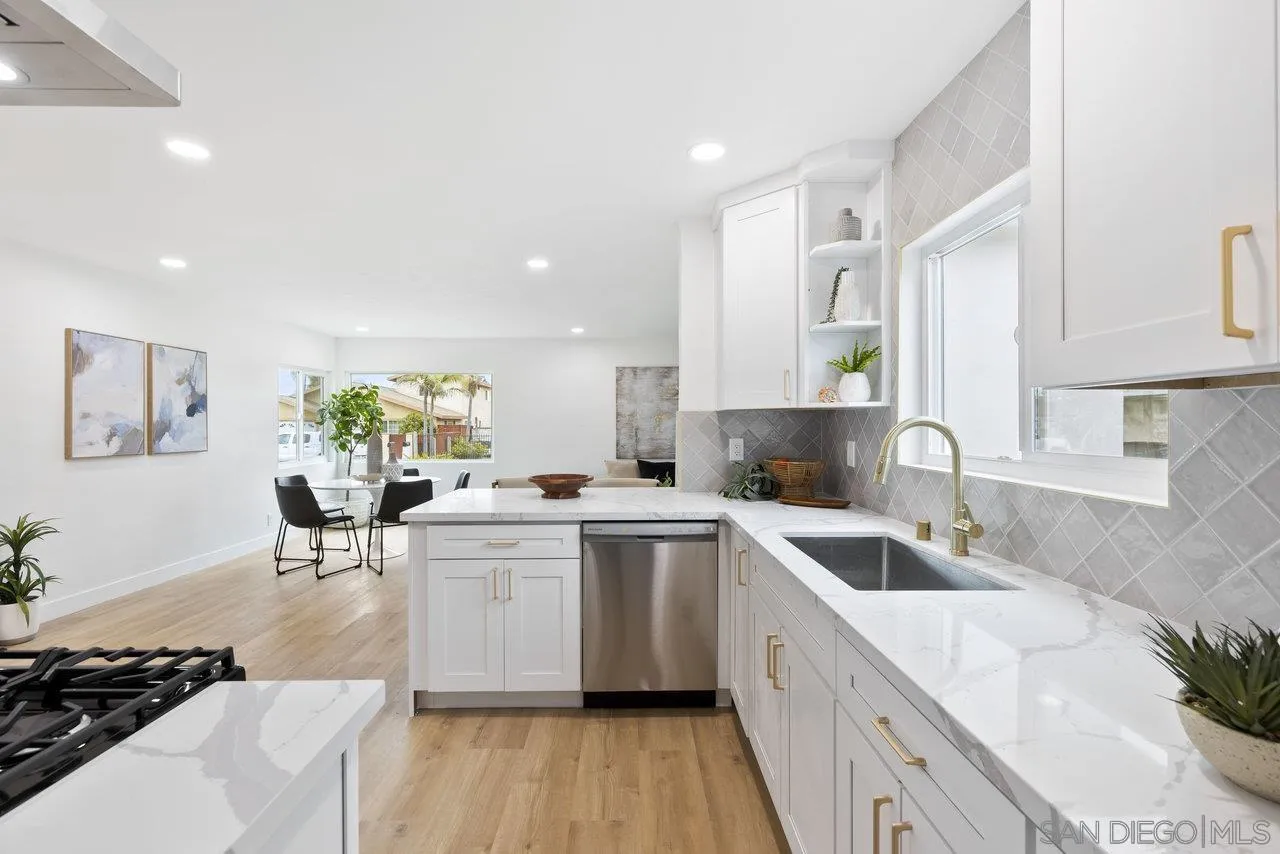 1320 Higgins Street Oceanside, CA 92058 - Photo 5 of 25 a kitchen with a sink stove and cabinets
