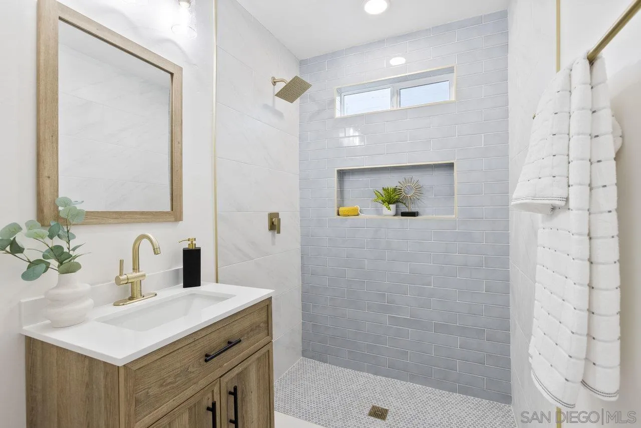 1320 Higgins Street Oceanside, CA 92058 - Photo 7 of 25 a bathroom with a sink a toilet and shower