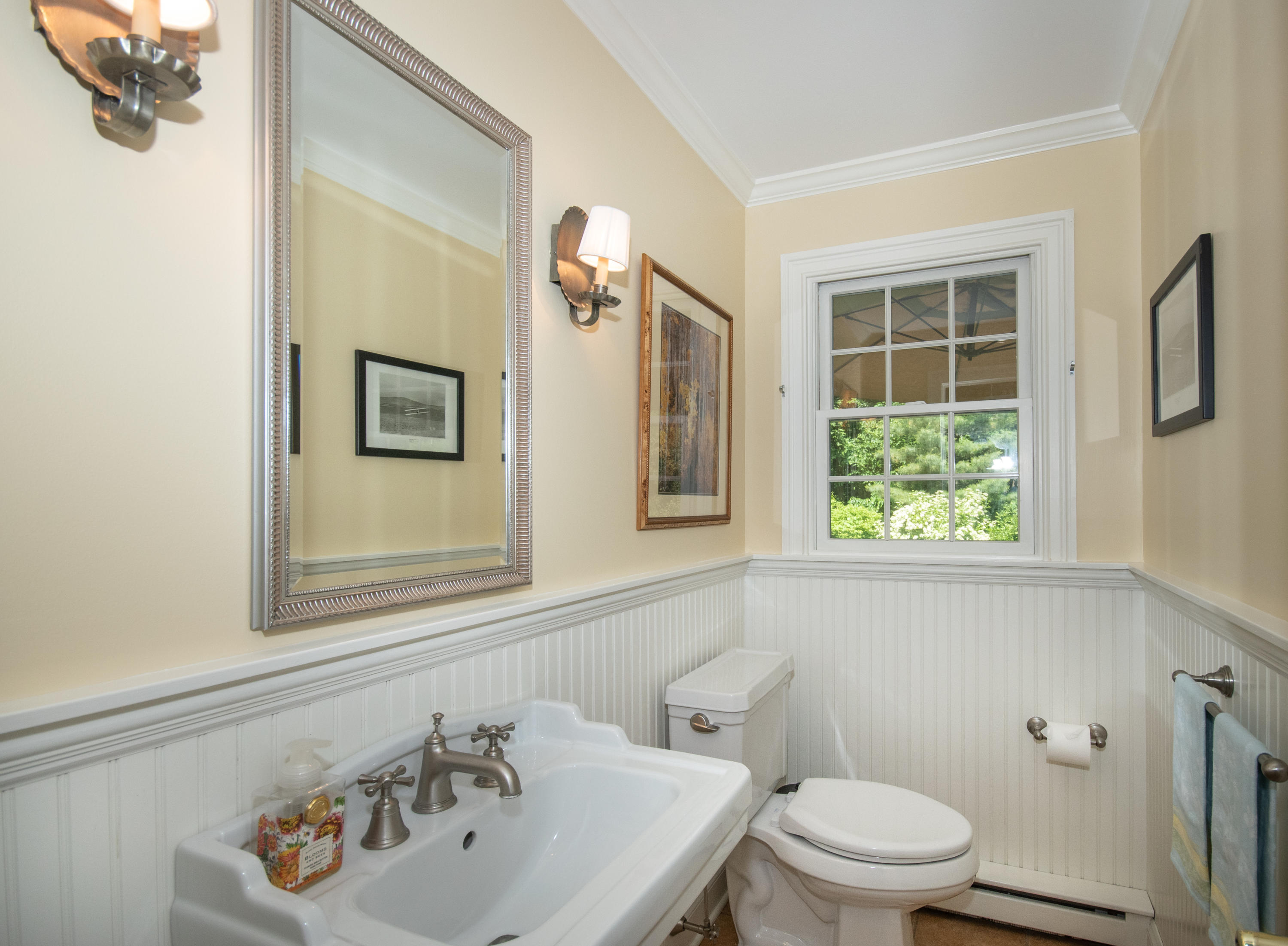 71 Rocky Brook Road New Canaan, CT 06840 - Photo 12 of 28 a bathroom with a sink a toilet and a mirror