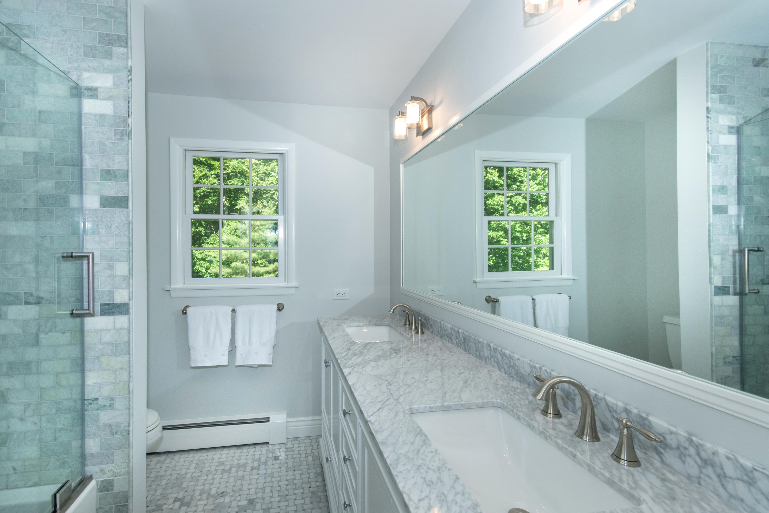 71 Rocky Brook Road New Canaan, CT 06840 - Photo 15 of 28 a bathroom with a granite countertop sink a mirror and a bathtub