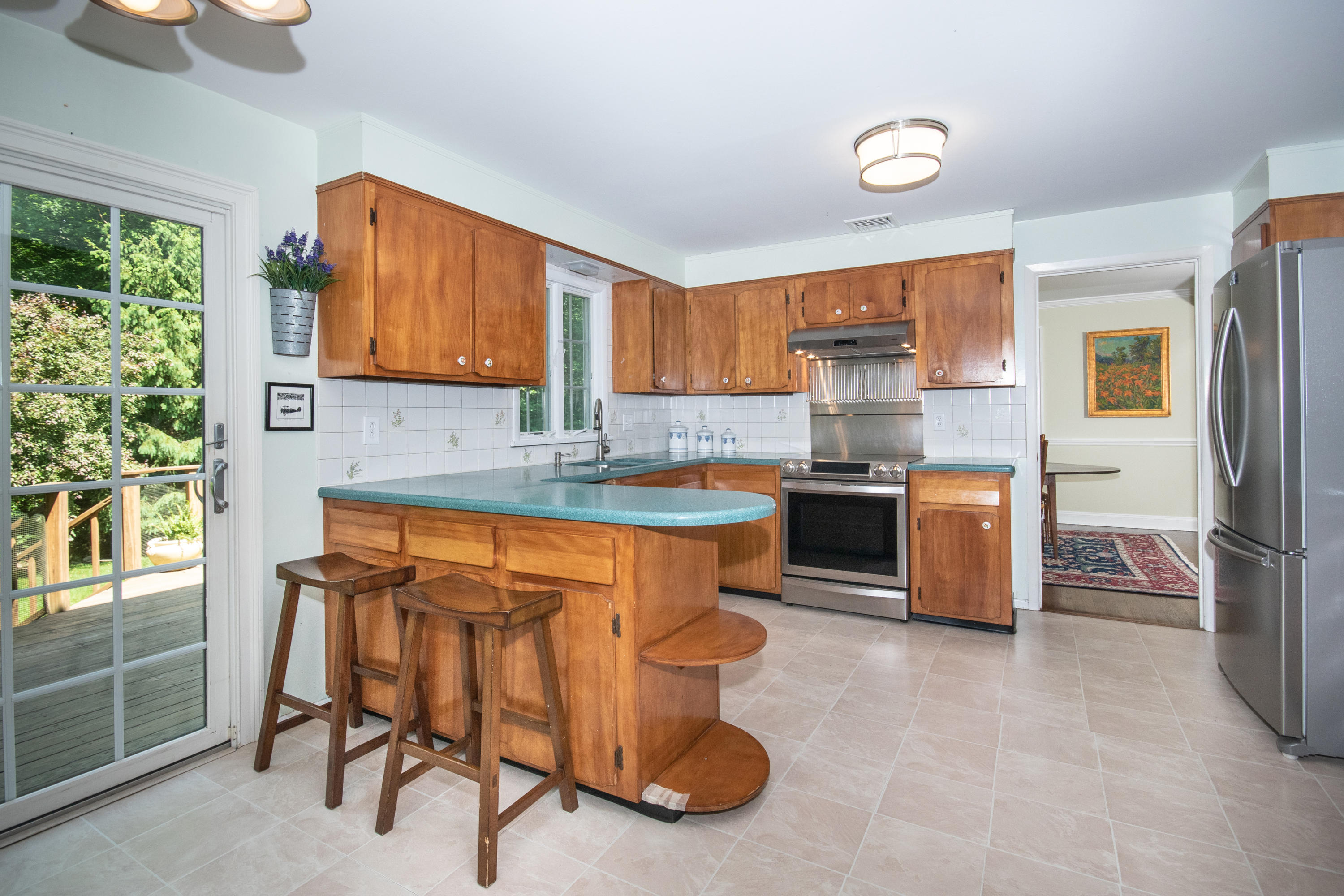 71 Rocky Brook Road New Canaan, CT 06840 - Photo 10 of 28 a kitchen with stainless steel appliances granite countertop a stove a sink and a refrigerator