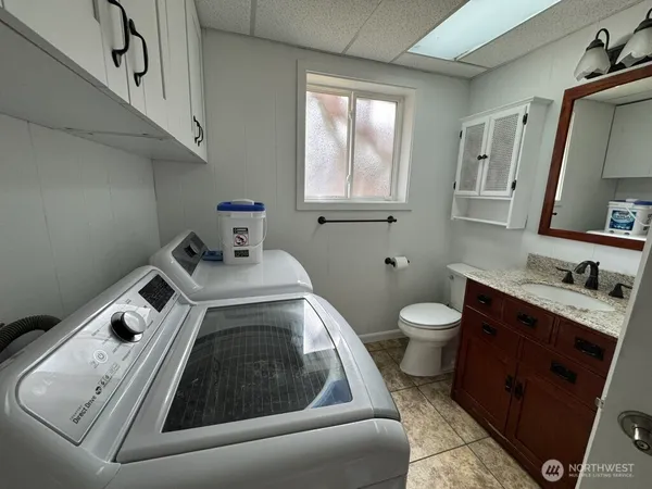 a bathroom with a toilet sink and mirror