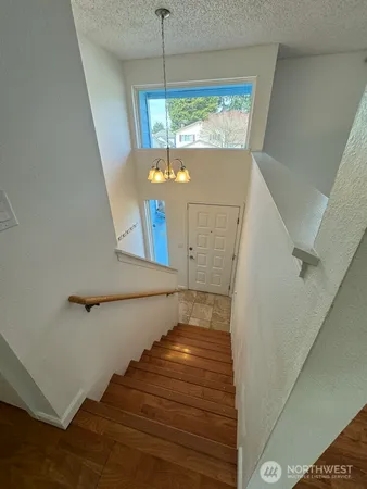 a view of entryway and hall with wooden floor