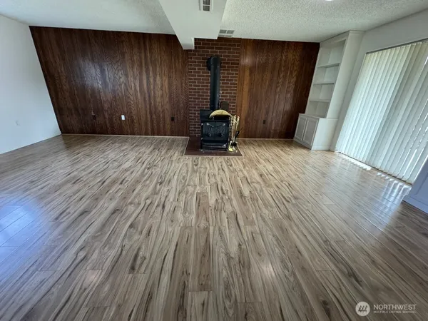 a view of a room with wooden floor and stairs