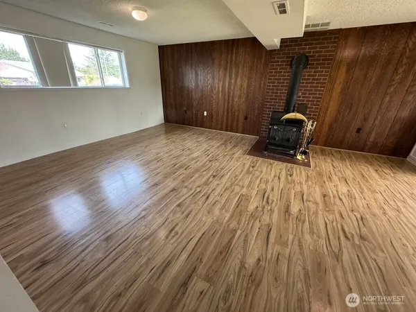 a view of wooden floor and brick walls