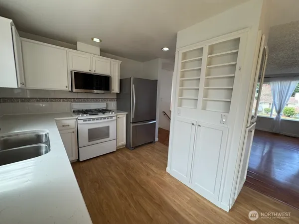 a kitchen with a stove a microwave and a refrigerator