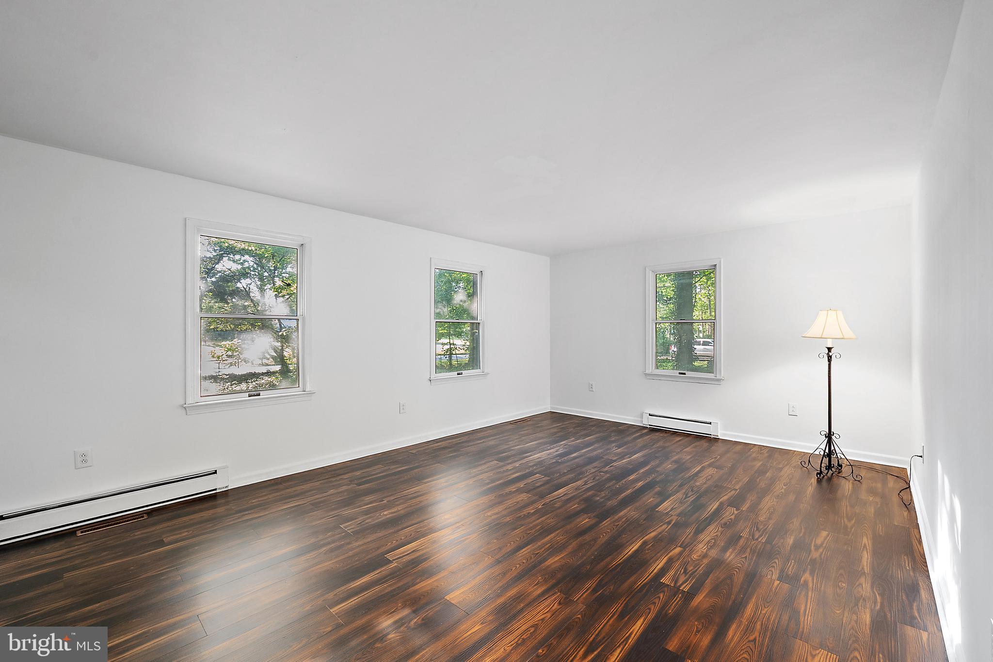 6181 Rockawalkin Road Salisbury, MD 21801 - Photo 23 of 65 a view of an empty room with wooden floor and a window