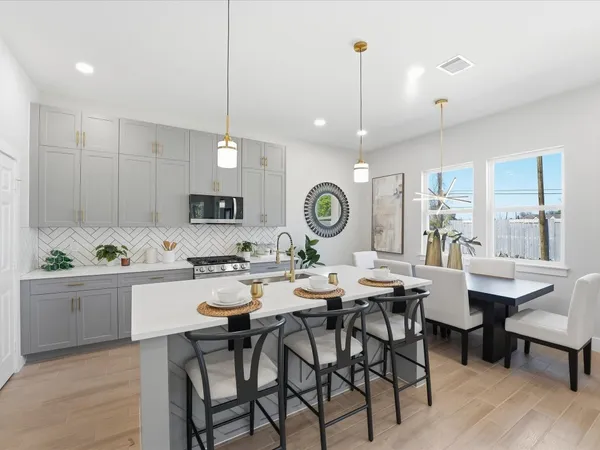 a kitchen with a dining table and chairs