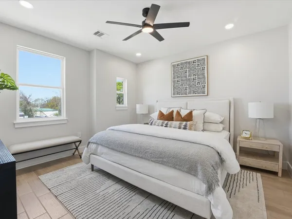 a bedroom with a large bed and a window