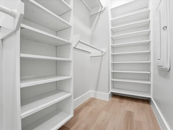 a view of walk in closet with empty racks