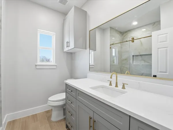a bathroom with a sink toilet and shower
