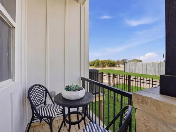 a view of a balcony with furniture