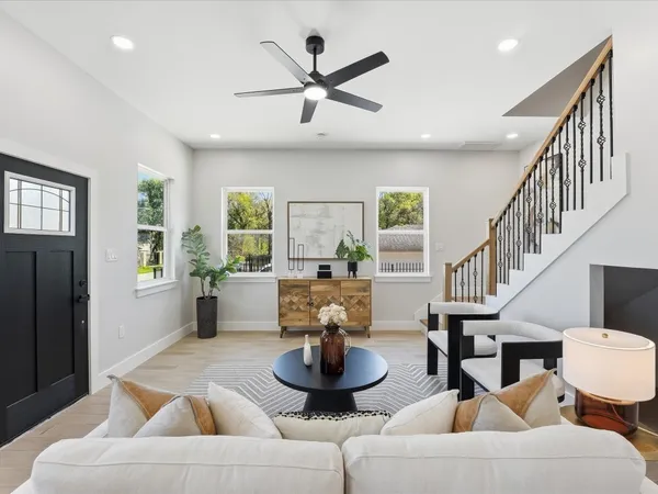 a living room with furniture a window and a chandelier