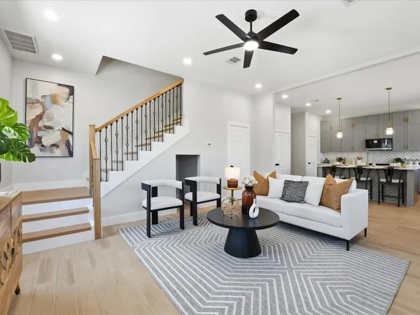 a living room with furniture and kitchen view