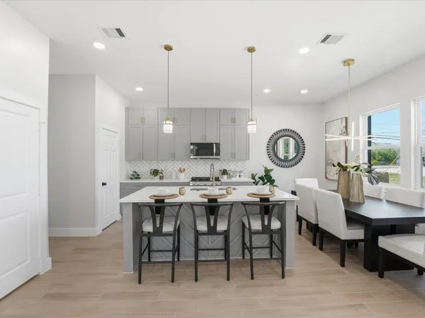a kitchen with a table and chairs in it